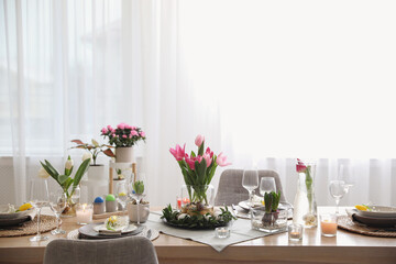 Beautiful Easter table setting with beautiful flowers in living room