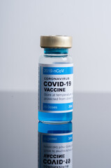 Medical concept ampoules or vials with Covid-19 vaccine on a laboratory bench