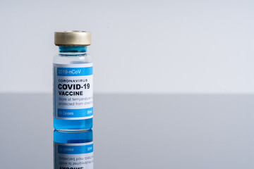 Medical concept ampoules or vials with Covid-19 vaccine on a laboratory bench