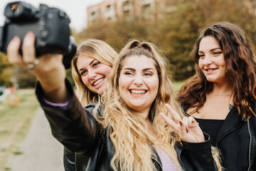 Friends taking selfie with camera