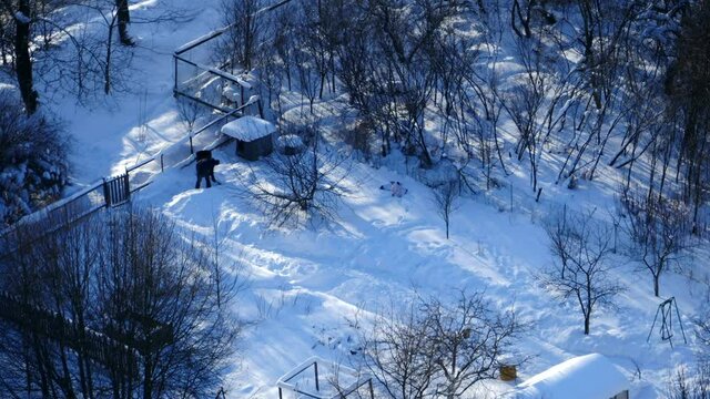 Man With Snow Shovel Cleans Footpath Winter Landscape, View From Above, Time Lapse