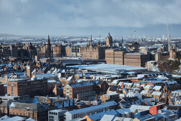 Top view of the winter city of Edinburgh covered snow. City attractions. Scotland, United Kingdom
