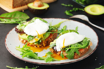 Homemade sandwiches with salmon, avocado and poached eggs