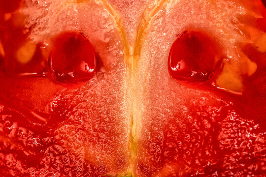 Extreme close-up macro image of a sliced ripe tomato