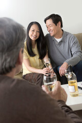 Mature friends socialising with white wine