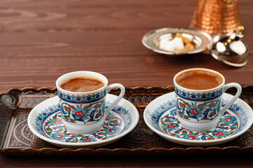 Cup of coffee in oriental style on metal tray