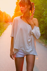 Portrait of a young woman in the summer at sunset