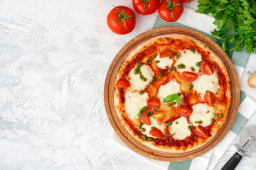 Top view of pizza Margherita on gray surface
