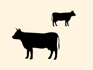 Two black silhouettes of a cow on a light background