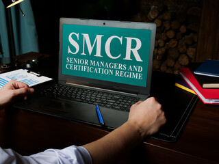 Senior Managers and Certification Regime SMCR on the laptop.