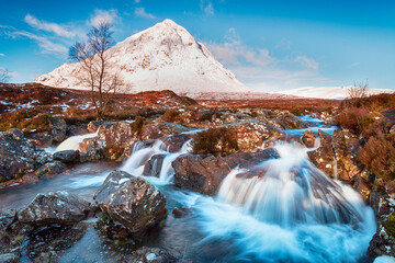 Snow topped mountains and waterfalls at Glen Etive