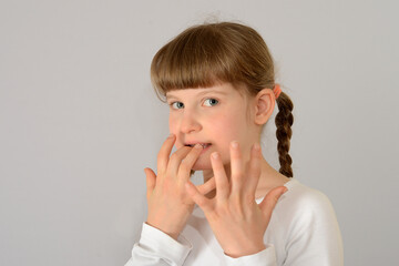 cute little girl gnaw bites her fingernails kid child