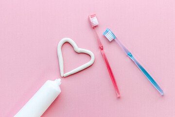 Teeth hygiene. Toothbrush with heart shape made of toothpaste, top view