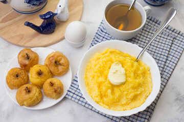 A delicious and healthy breakfast with corn porridge and baked apples.