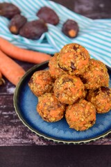 Carrot oat date energy balls. Gluten free and vegan food. Wooden background