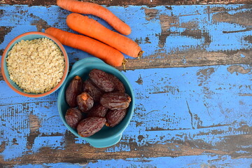 Carrot oat date on blue wooden background