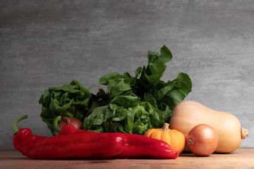 Mix of healthy vegetables on wooden table.
