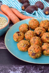 Carrot oat date energy balls. Gluten free and vegan food. Wooden background