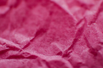 Crumpled pink paper. Macro photography of paper. Texture and background.