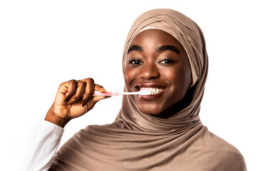 Muslim black woman in hijab brushing teeth