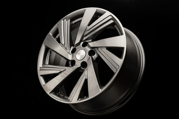 gray alloy wheel modern, close-up side view on a black background