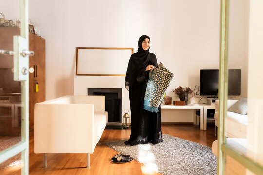 Young muslim woman with prayer mat