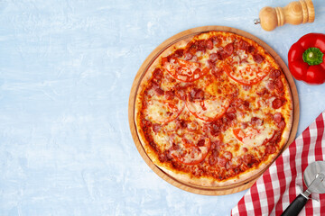 Delicious pizza with sausages on gray background