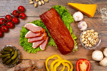 Assortment of cold cuts, a variety of processed cold meat products. On a wooden background