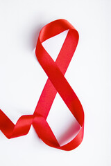 Number 8 from red silk ribbon on a white background. International women's day symbol. Spring holiday on March 8.