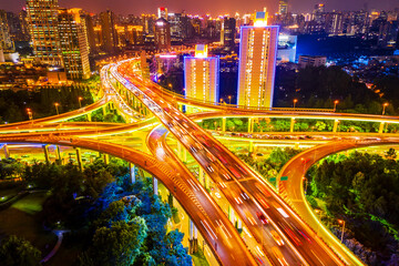 Aerial view of buildings and highway interchange at night in Shanghai,China.