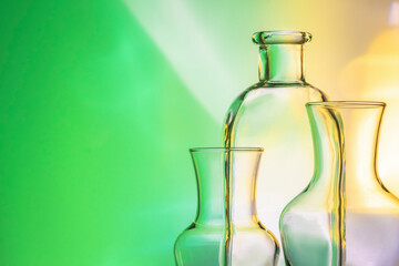 items utensils to the light. glass bottles, vases on a yellow-green background