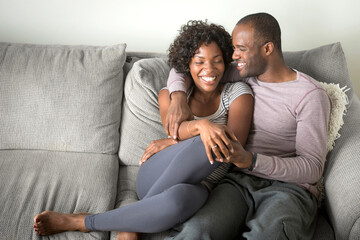 Portrait of mid adult couple sitting on sofa