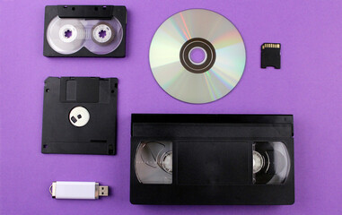 A set of various storage media: disk, flash drive, video cassette, audio cassette, floppy disk, sd...