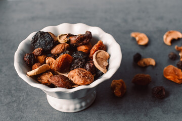Dried fruits on a white plate.
assortment dried fruits close up.
dried fruits, apples, pears, apricots, plums, grapes