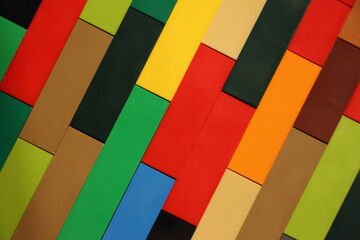 Colored plastic bricks mosaic block diagonal lines texture surface, children's construction kit background