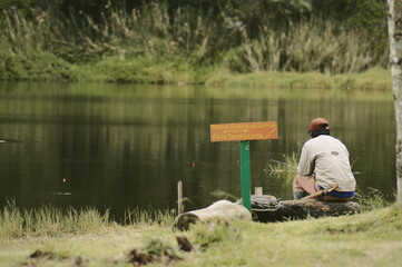 A man who is fishing in a lake, this lake is located at an altitude of about 1,700 mdpl.