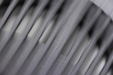 Gray blurred plastic fan grille motion, abstract technical background
