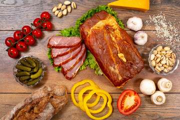 Assortment of cold cuts, a variety of processed cold meat products. On a wooden background