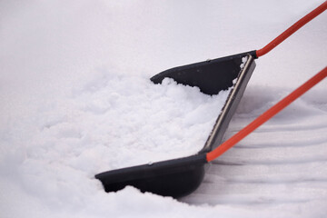 A snow shovel is used to clean the snow outside. The concept of winter snow cleaning
