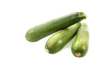 Three fresh green zucchini isolated on white background