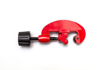 Red pipe cutter for plumbing repairs on white isolated background