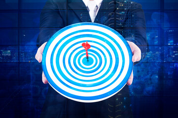 Businessman holding a dartboard with code binary