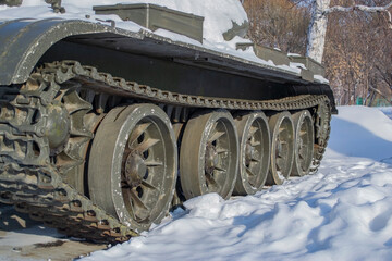 The caterpillar of the tank, the tank is standing on the snow.