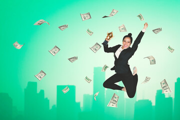 Businesswoman holding a trophy with falling money