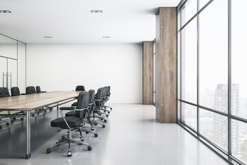 Light spacious meeting room with wooden conference table, black chairs around, glossy floor and big window