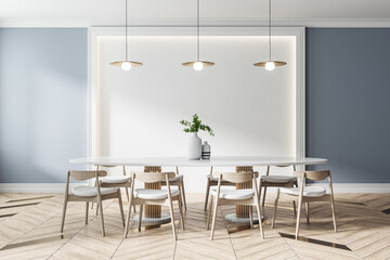 Front view on modern wooden chairs around white table in light dining room with stylish chandelier...