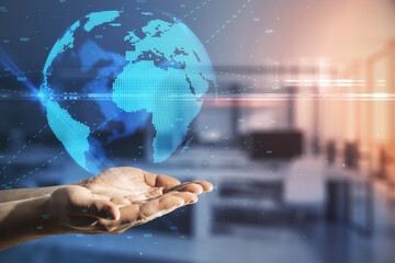 Global social communication concept with man hands and Earth with citylights hologram projection over it