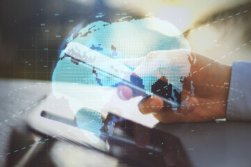 Global telecommunication concept with hologram World planet and citylights at businessman hand with modern cell phone