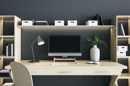 Blank Black Computer Monitor Screen With Lamp And Vase On Wooden Desk Table In Eco Style Interior Room. Mock Up