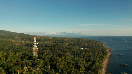Fototapeta na wymiar Antennas and microwaves link dishes of mobile phone network and TV transmitter on telecommunication towers aerial view. Camiguin, Philippines